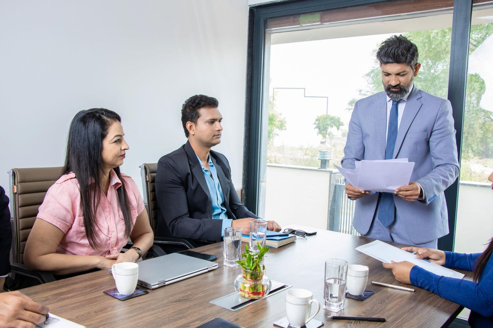Business partners signing a partnership deed in India